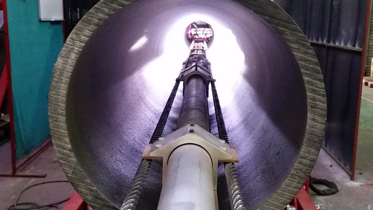 Twin head pipe cladding rig